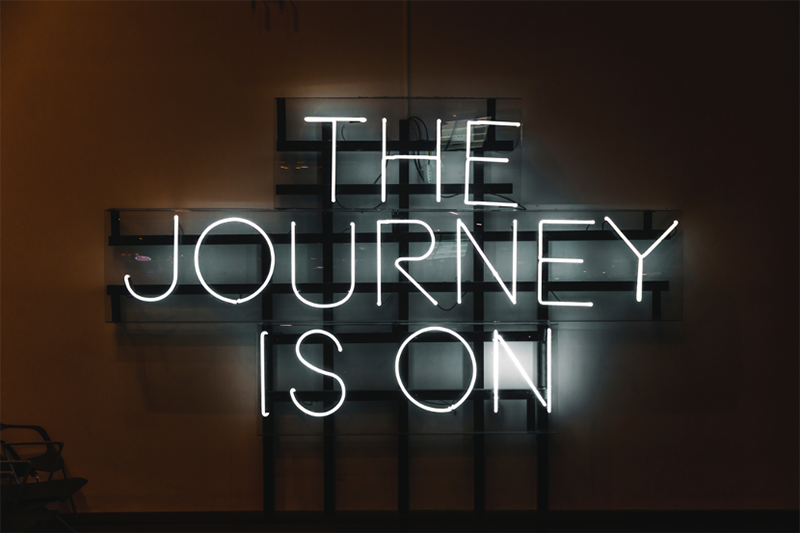 Neon sign with "The Journey is on"