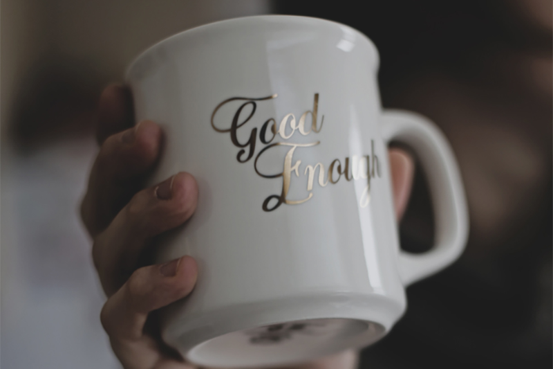 Whit mug with gold writiing "Good Enough"